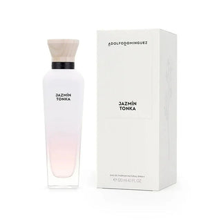 Frasco de perfume ‘JAZMIN TONKA’ da ADOLFO DOMINGUEZ, com gradiente de cor de claro a rosa, ao lado da sua caixa de embalagem branca.